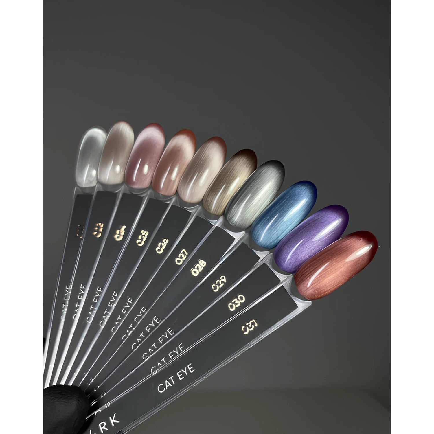 Cat eye gel nail polish color swatches in various metallic shades for manicures