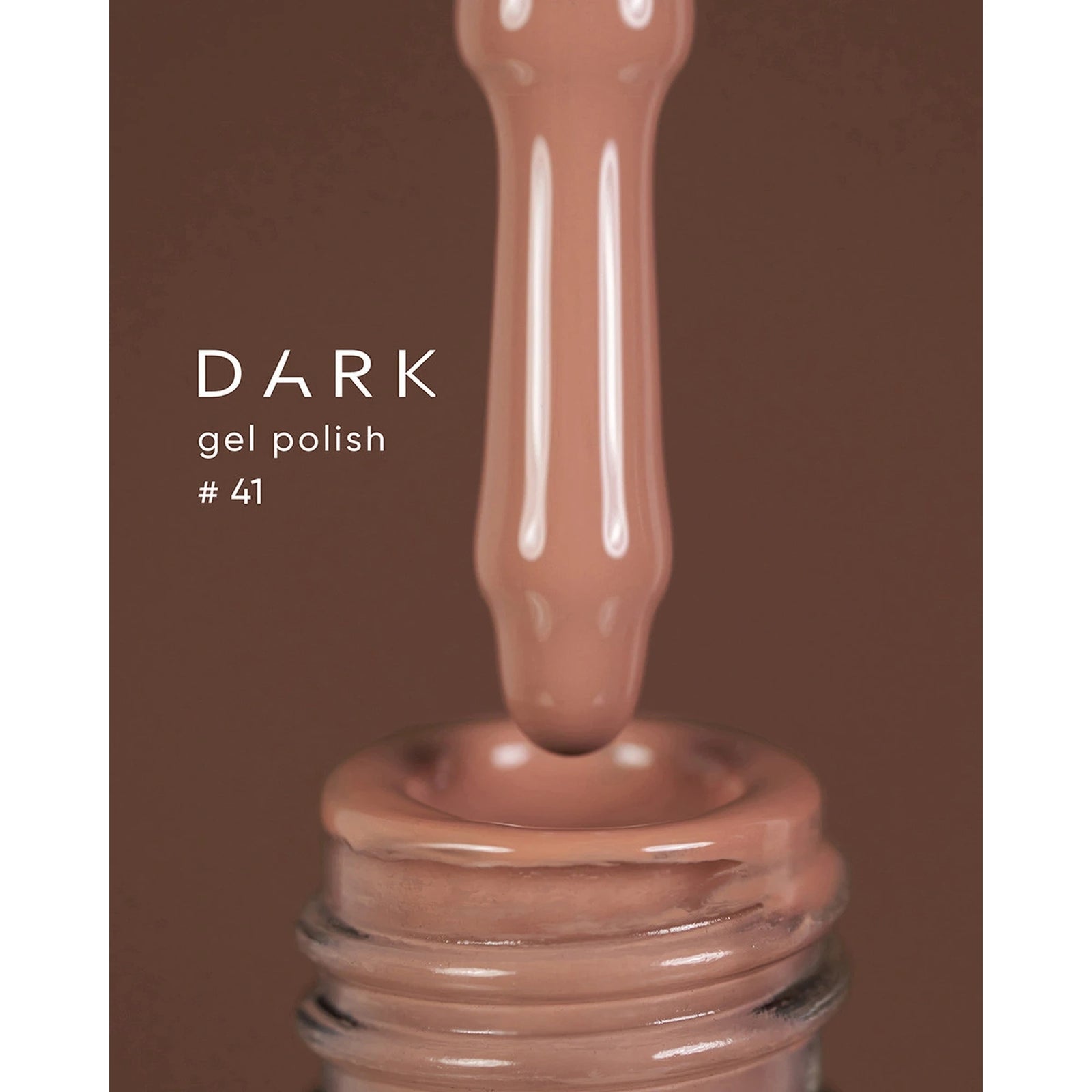 Dark gel polish #41, brown nude UV gel dripping from brush into bottle.