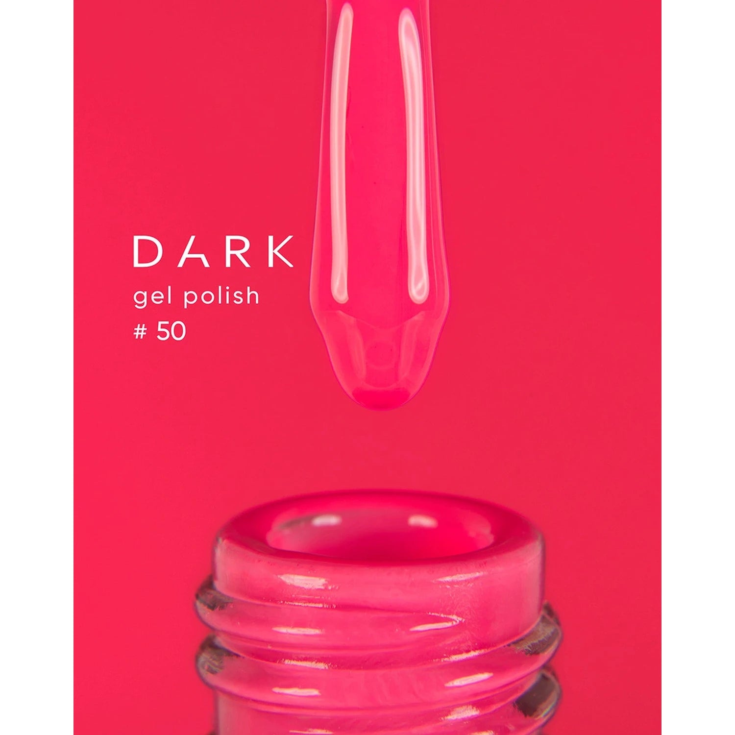Bright pink gel nail polish #50 on brush above open bottle, manicure product closeup
