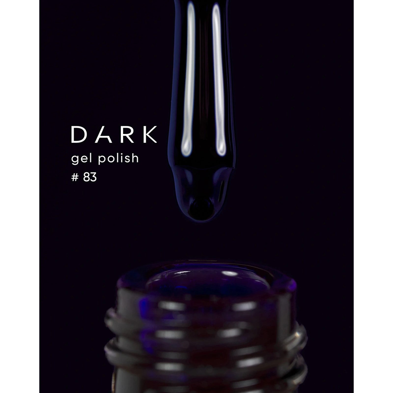 Dark gel polish #83 dripping from brush into open nail polish bottle, black background
