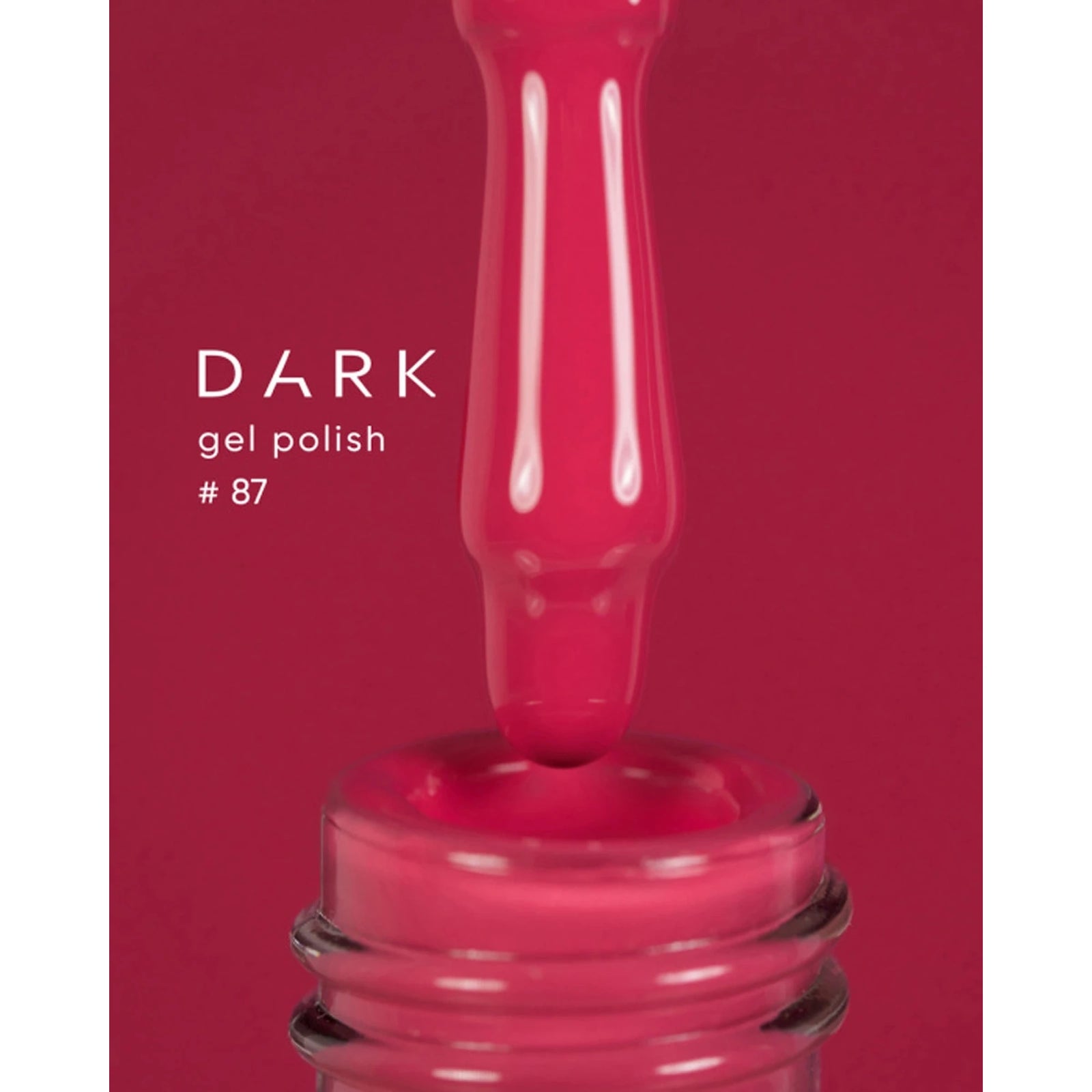 Dark pink gel polish bottle with brush, shade #87, close-up for manicure