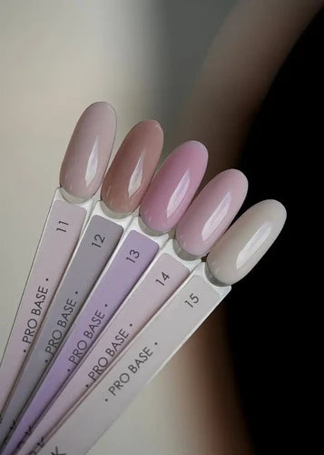 Set of five nail polish color samples in natural pink and nude shades for gel manicure.
