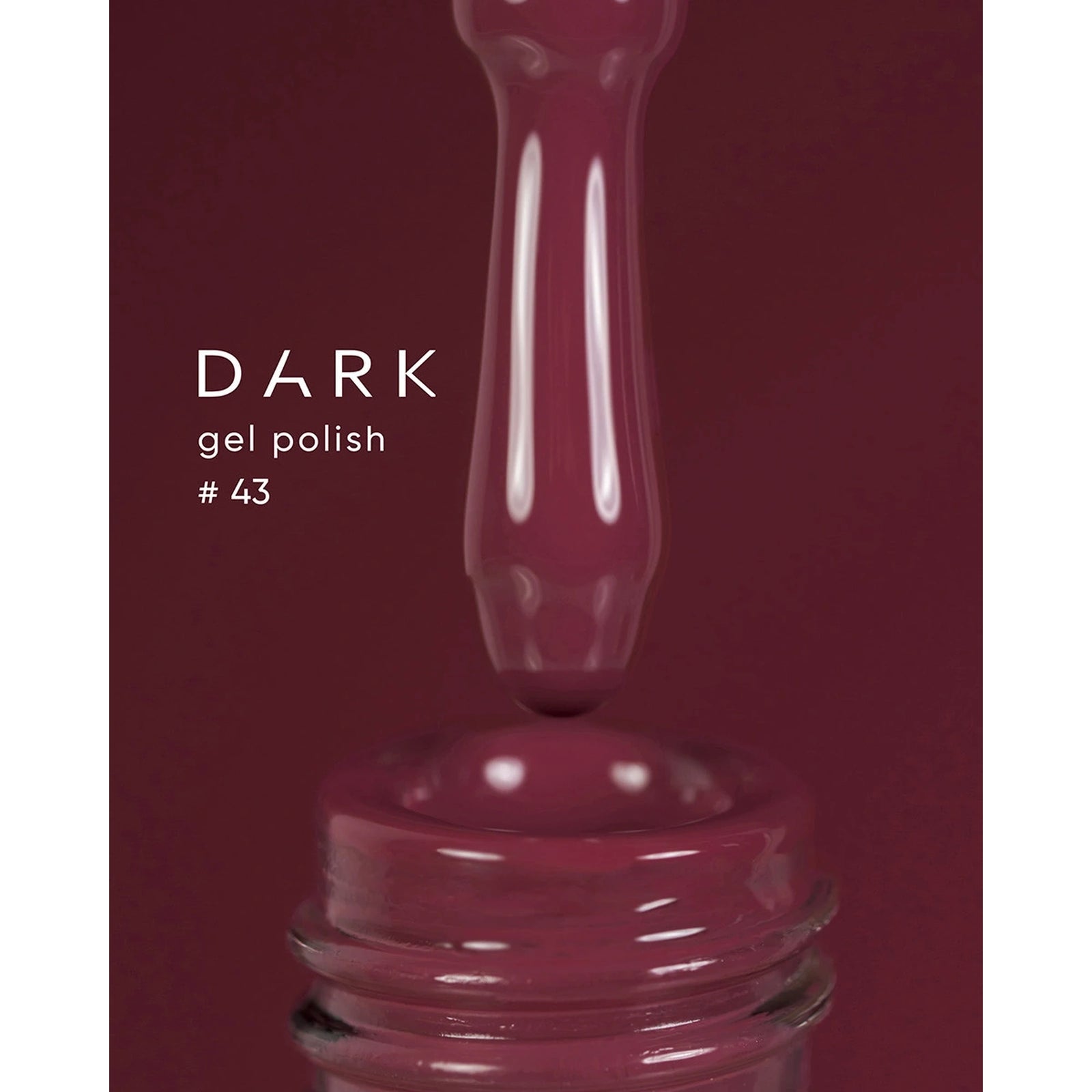 Dark gel polish #43, deep burgundy UV nail polish dripping from brush into open bottle