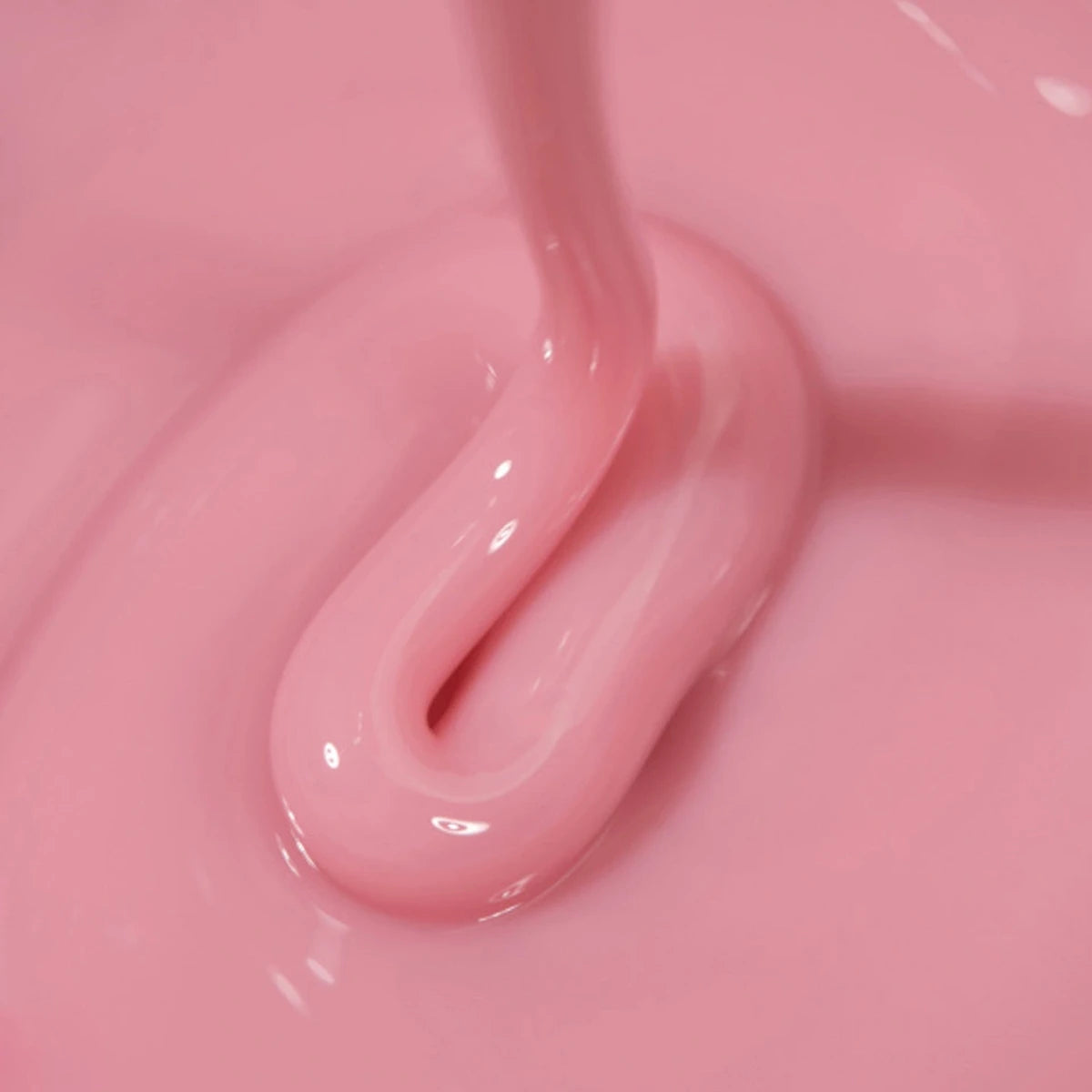 Pink UV gel for nails with glossy texture being poured, professional manicure nail product