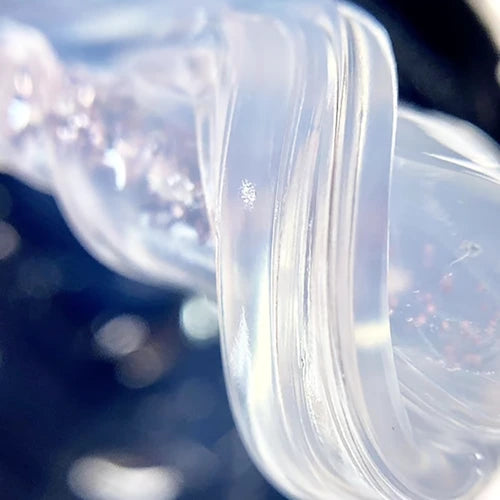 Close-up of clear UV nail gel with subtle glitter, perfect for manicure and nail art.