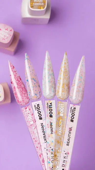 Colorful glitter nail gel swatches on clear sticks, purple background, manicure product