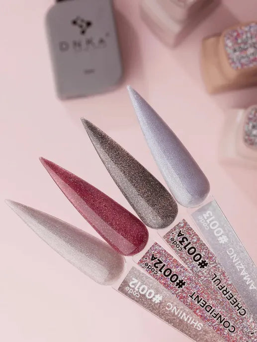 Four glitter gel nail polish color samples in silver, red, taupe, and lilac on swatch sticks