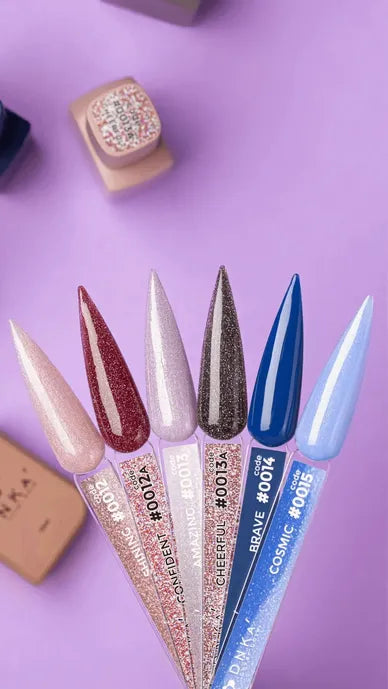 Assorted glitter and solid gel nail polish color swatches on display, purple background.