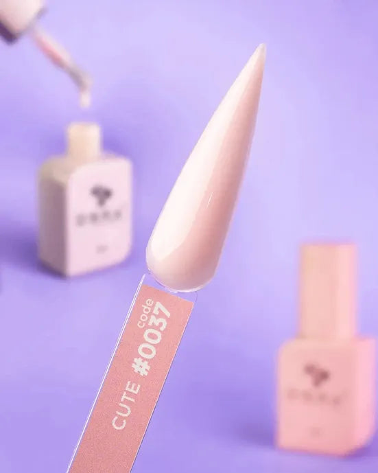 Light pink nail gel polish sample on a display stick labeled code 0037, with bottles in background
