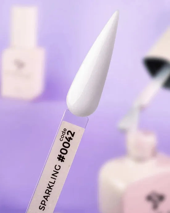 White sparkling gel nail polish swatch code 0042 on display stick, manicure accessory