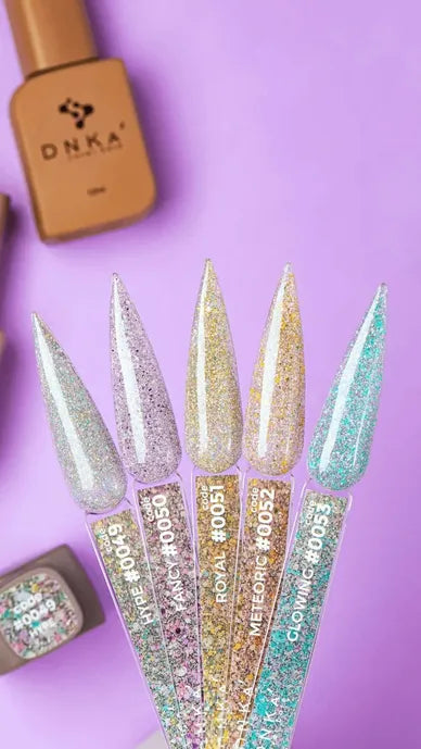 Glitter gel nail polish color swatches on clear nail tips over purple background, gold polish bottles nearby.