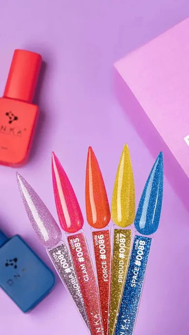 Five glitter gel nail polish samples in pink, red, orange, yellow, and blue on purple background