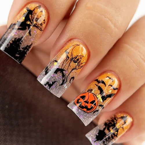 Halloween-themed nail art with pumpkins and cats on a person&
