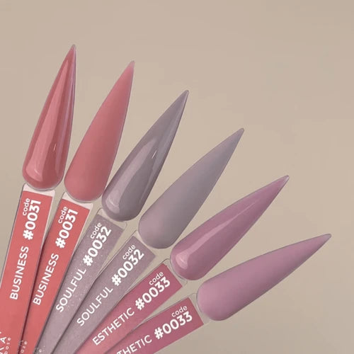 Nail color sample sticks in pink, mauve, and purple shades for manicure display.