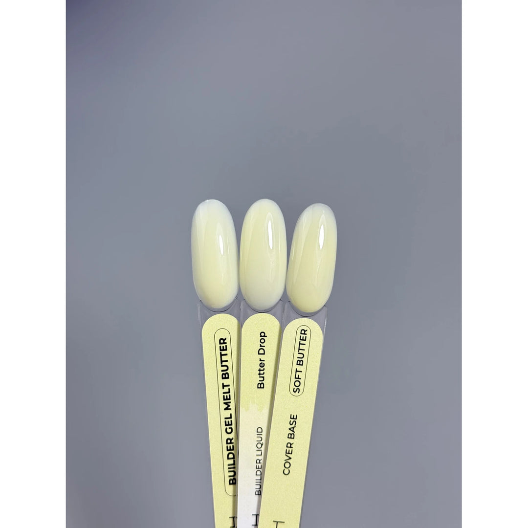 Three nail gel color swatches in pale yellow shades on labeled sticks for manicure