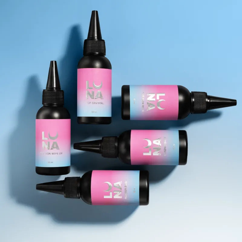 Five black manicure gel bottles with pink and blue labels on a blue background