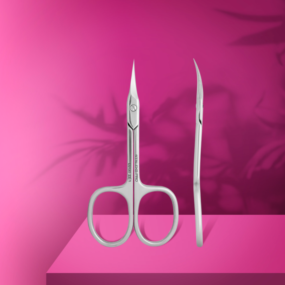 Stainless steel curved nail scissors for manicure on a pink background