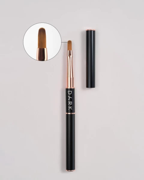 Professional nail gel brush with black handle and rose gold details, close-up bristles