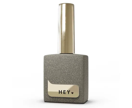 Gold shimmer gel polish bottle with metallic cap, glitter finish, and 'HEY' label for nails