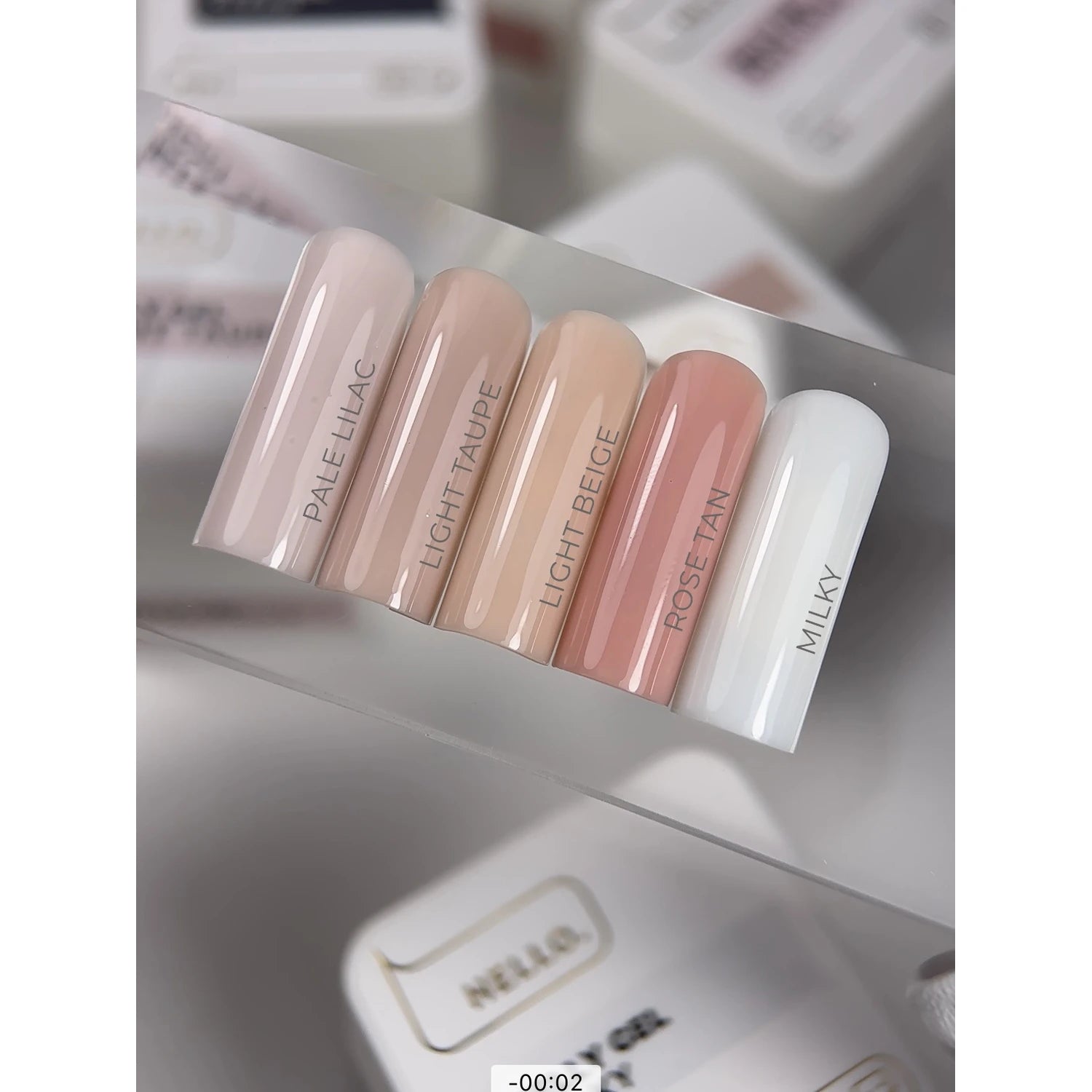 Nail color palette with pale lilac, light taupe, light beige, rose tan, and milky gel shades