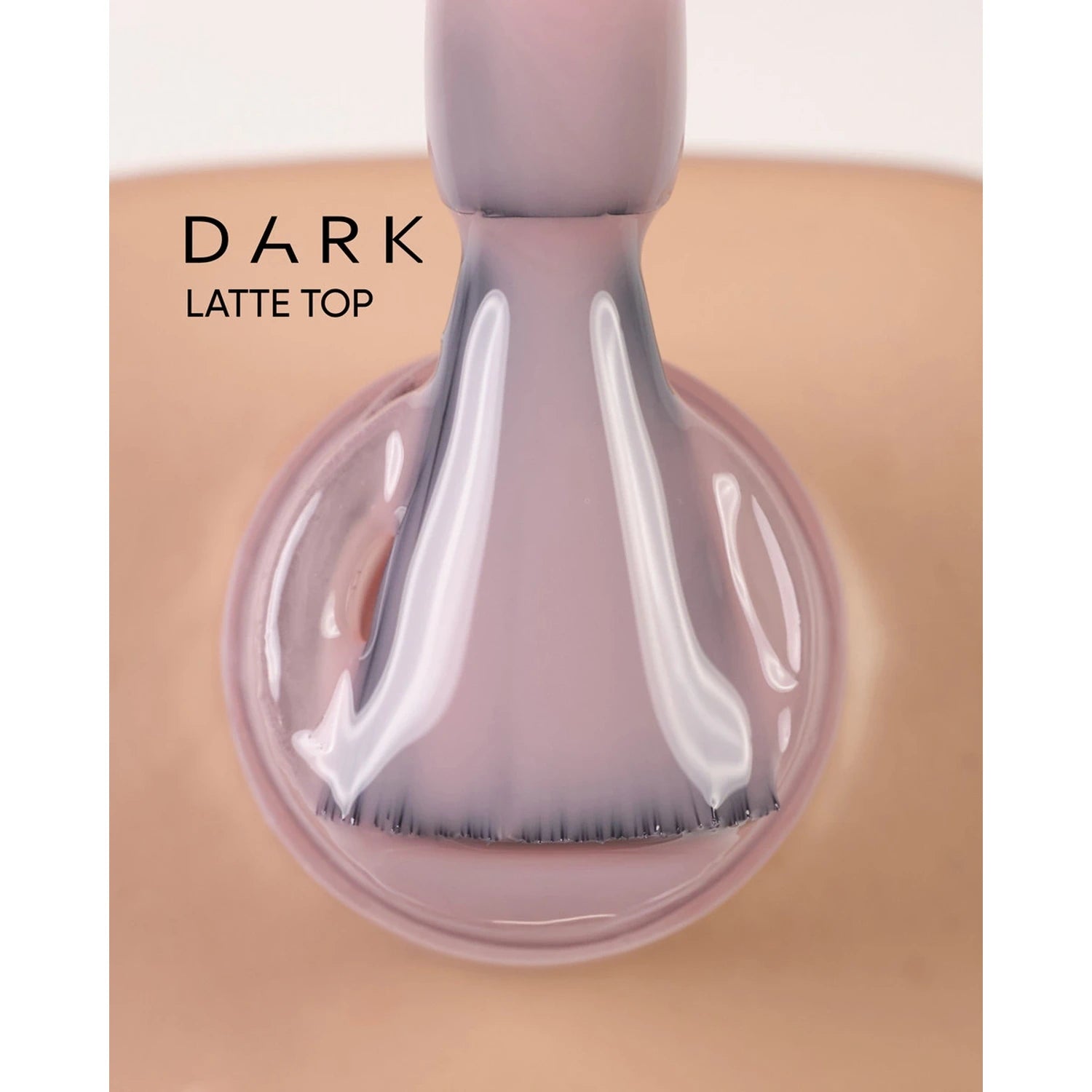 Dark latte top gel nail polish being applied with brush, close-up on natural nail.