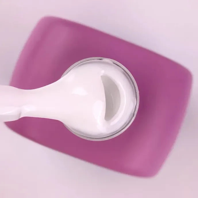 White builder gel for nails in a jar with a pink lid, used for manicures and nail extensions