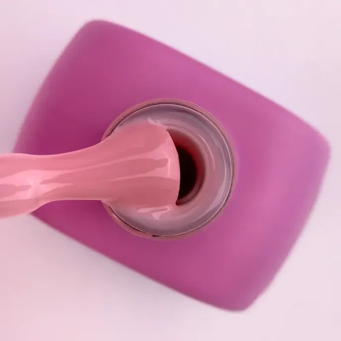 Pink builder gel for nails in a jar with brush applicator, ideal for manicures