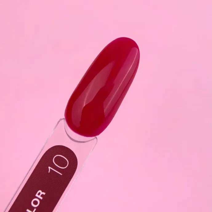 Glossy bright pink nail polish color sample on swatch stick, manicure product