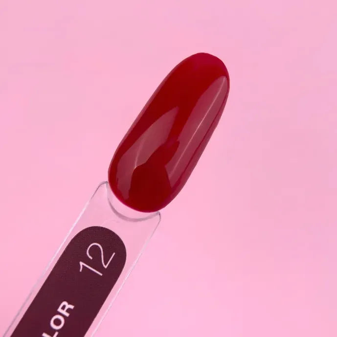 Red nail polish color swatch on display stick, number 12, with glossy finish on pink background