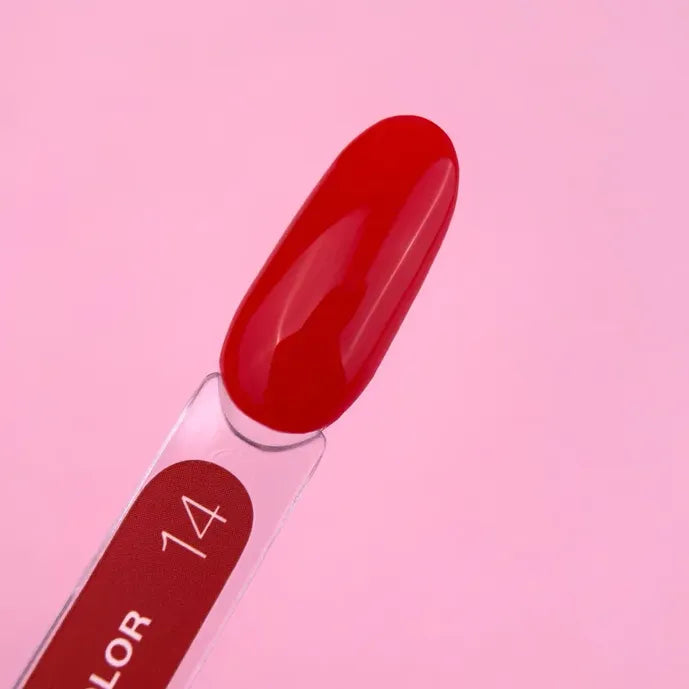 Glossy red gel nail polish swatch on stick, shade 14, against pink background
