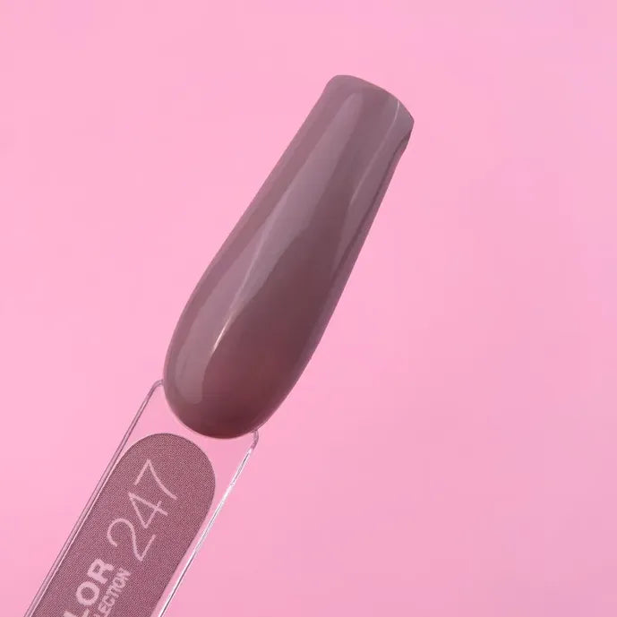 Mauve brown gel nail polish swatch on stick, shade 247, on pink background
