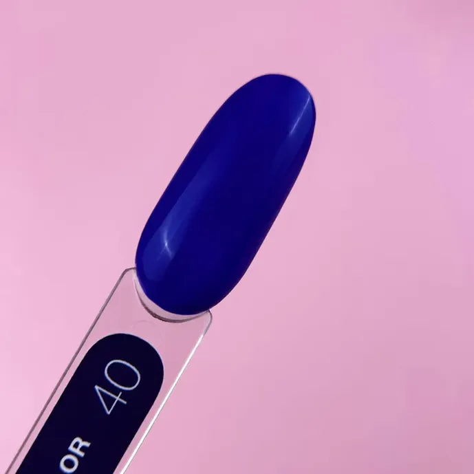 Blue UV gel nail polish color swatch on a sample stick with number 40, pink background