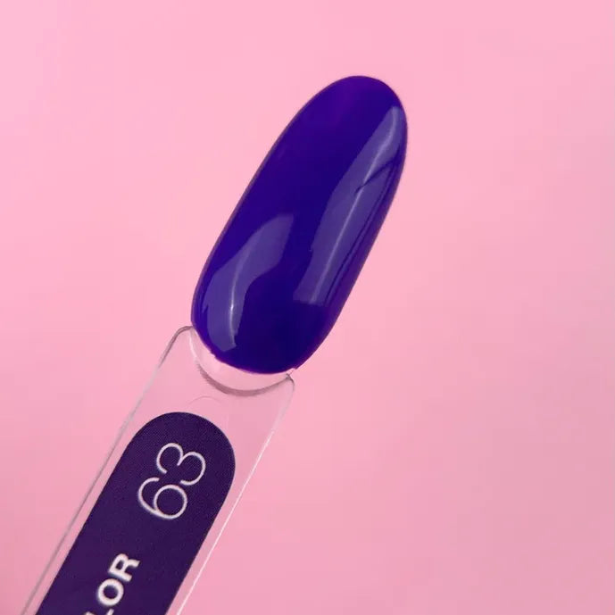 Glossy deep purple gel nail polish color sample on swatch stick with pink background