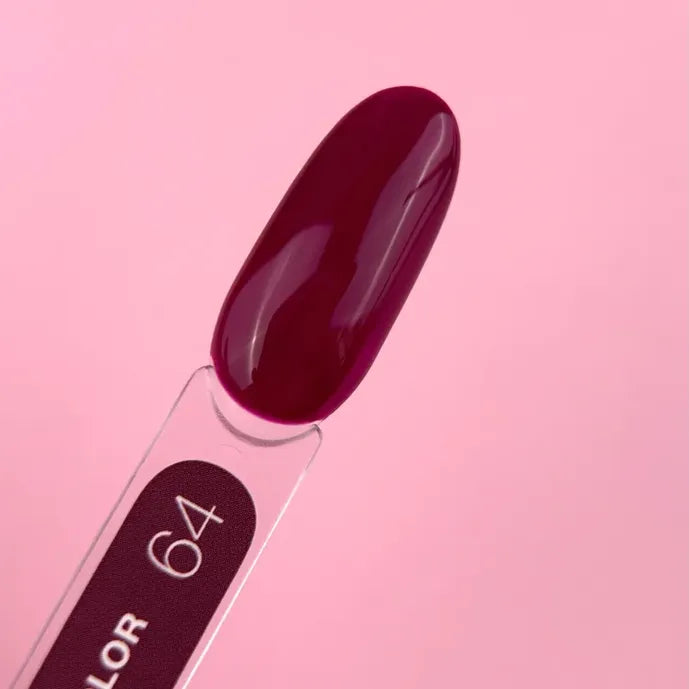 Deep burgundy gel nail polish swatch stick labeled 64 on a pink background