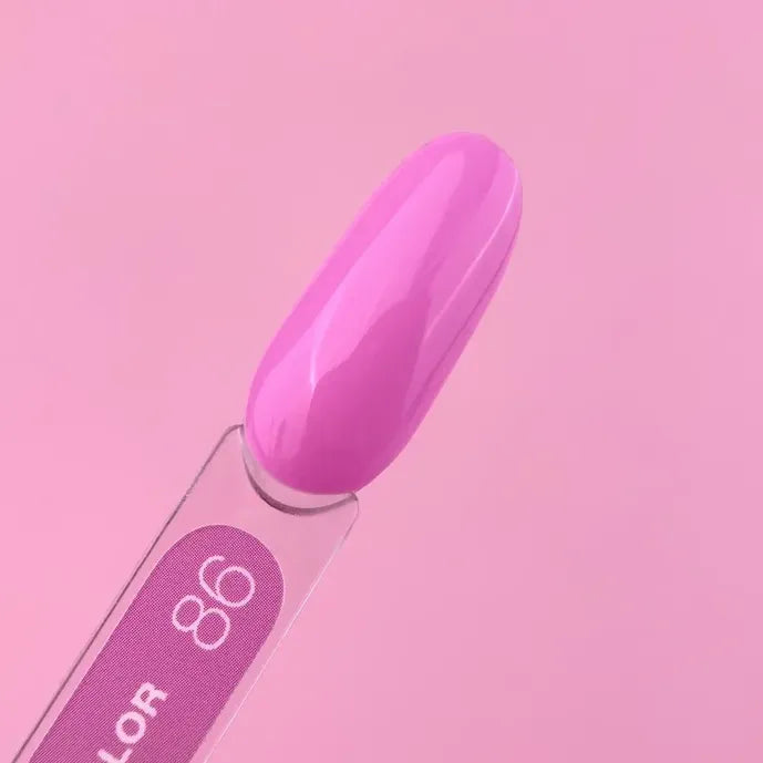 Glossy pink gel nail polish color sample on swatch stick with light pink background
