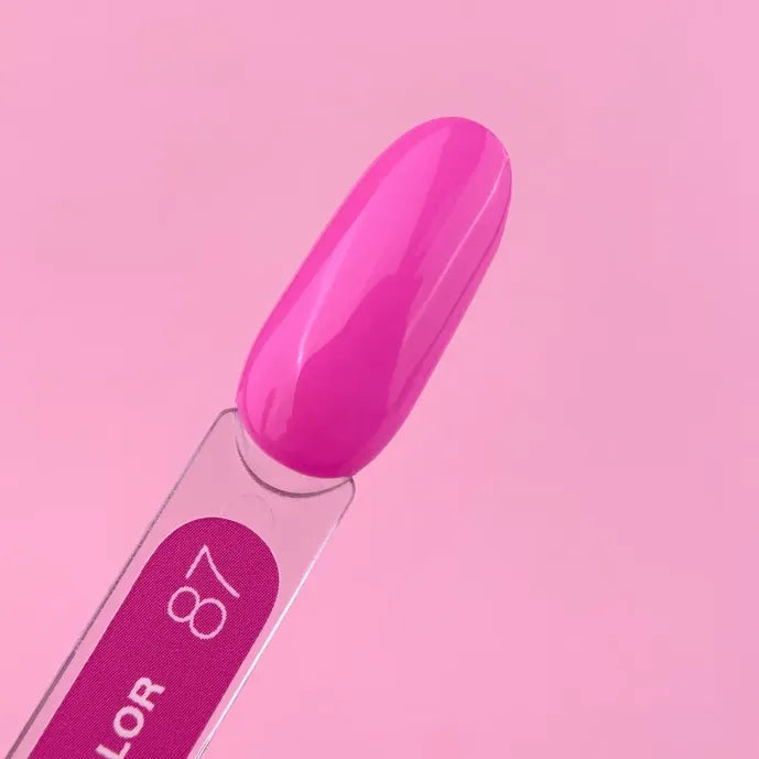 Bright pink gel nail polish swatch on sample stick against a pink background