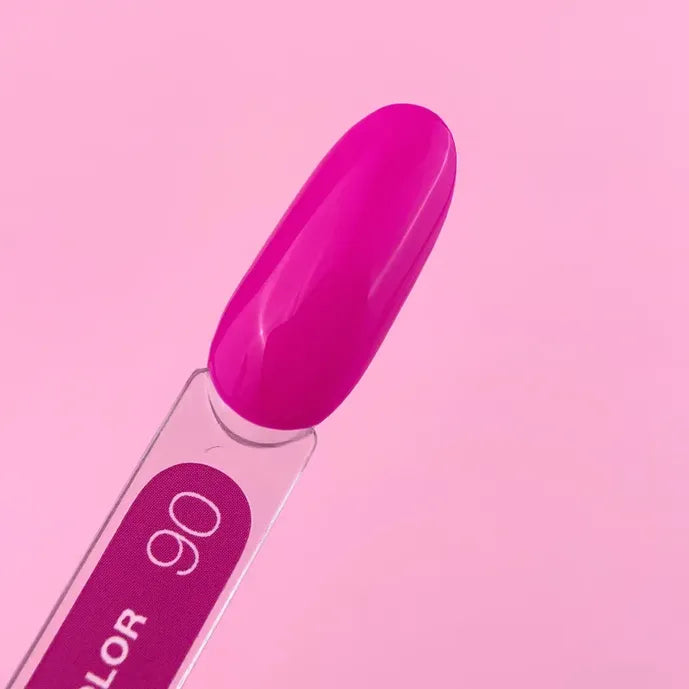 Vibrant pink gel nail polish color sample on a swatch stick, labeled 90, against pink background.