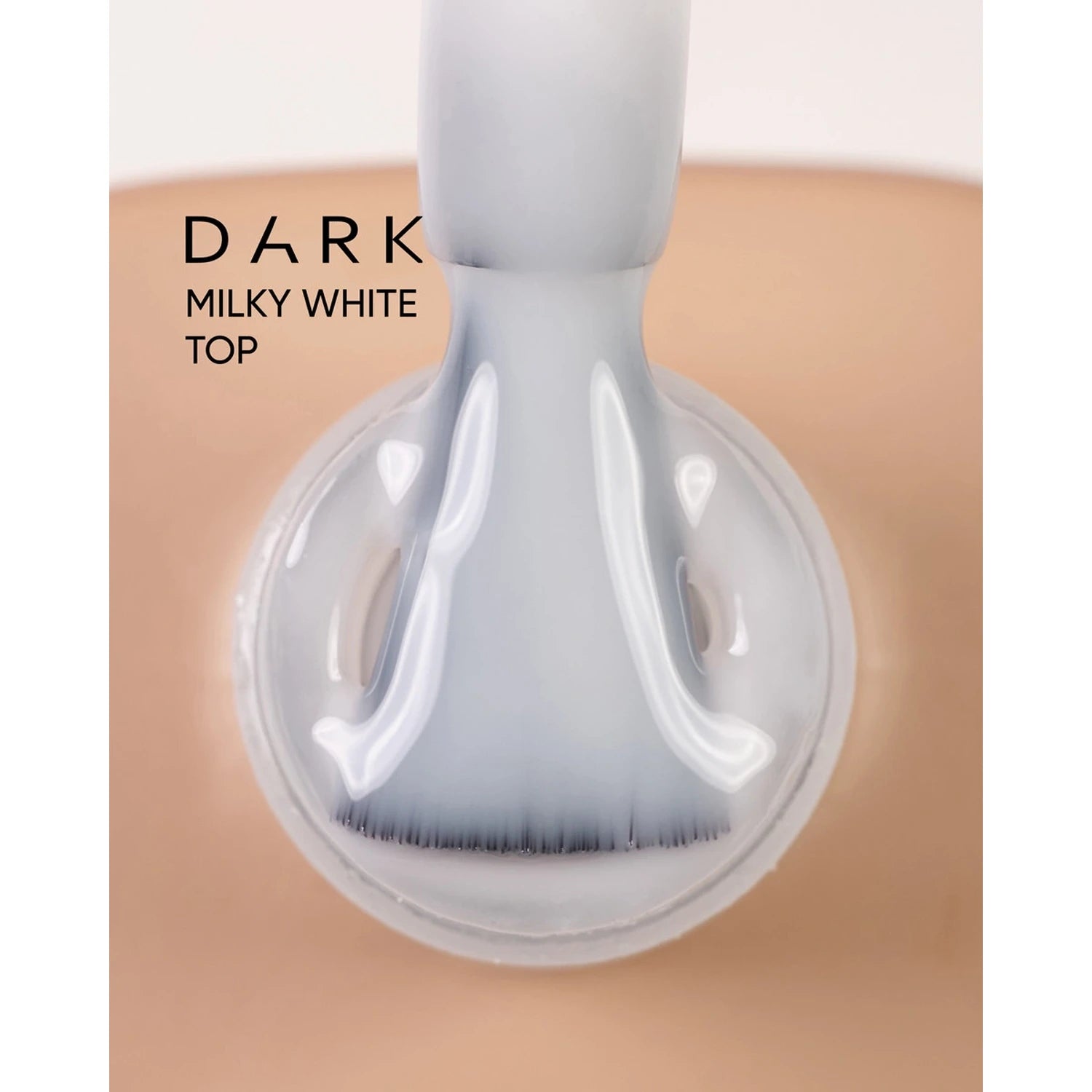 Brush applying dark milky white top gel on nail for manicure