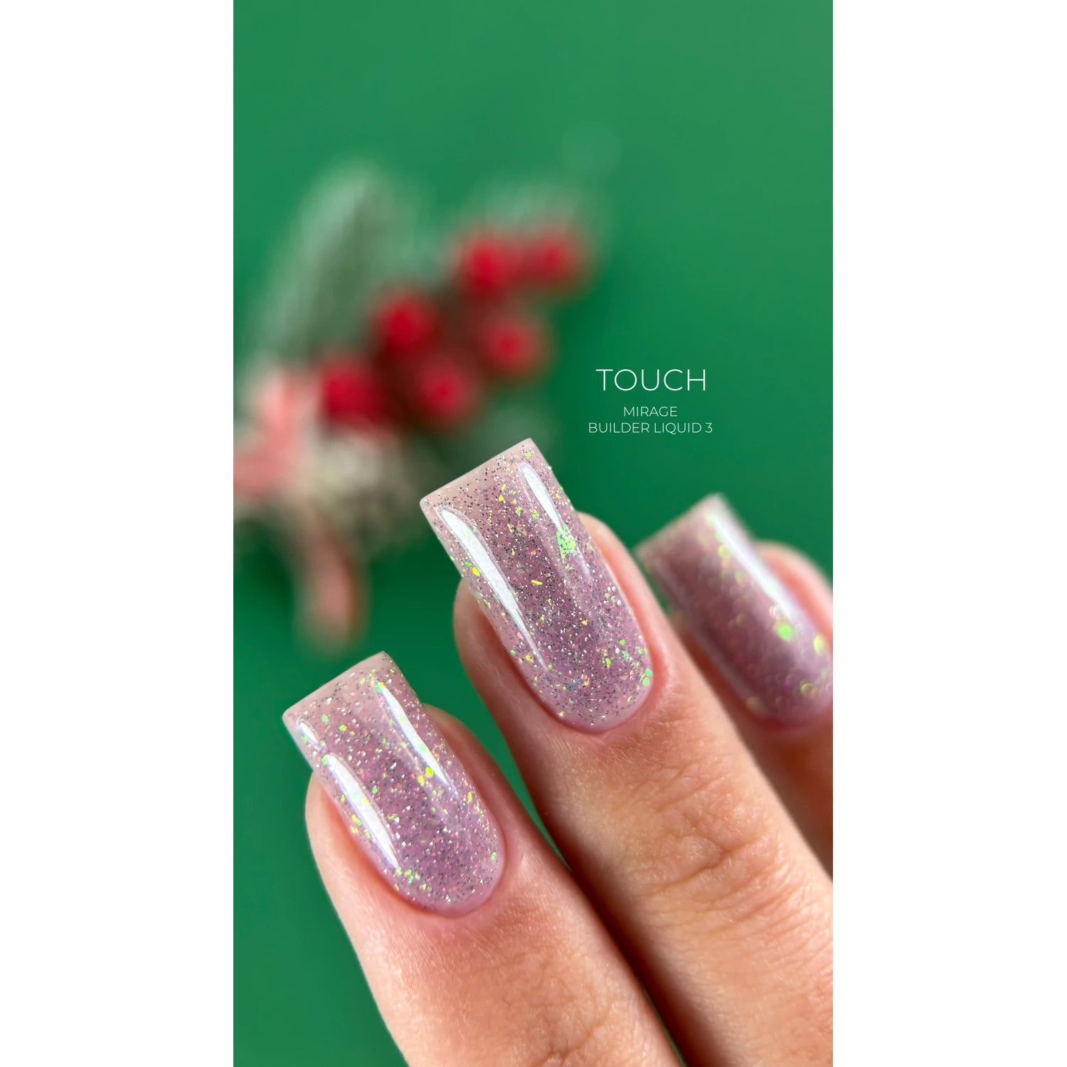 Hand with square-shaped nails featuring pink glitter gel polish, green background.