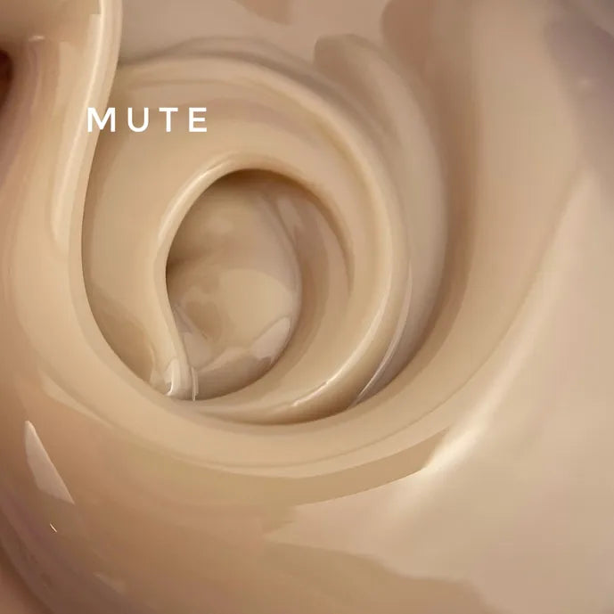 Swirl of beige UV gel nail polish with creamy texture and the word 'MUTE' on top.