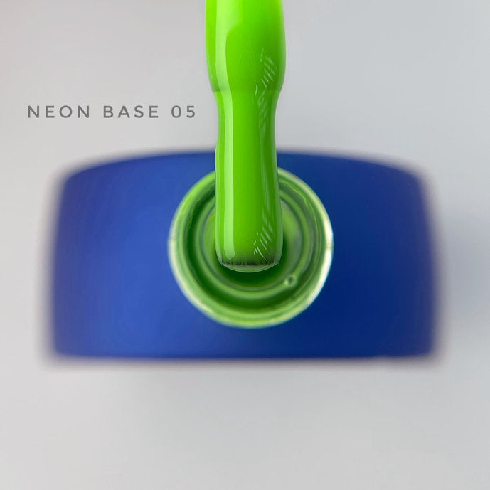 Neon green nail polish brush over open blue bottle, labeled Neon Base 05, manicure product