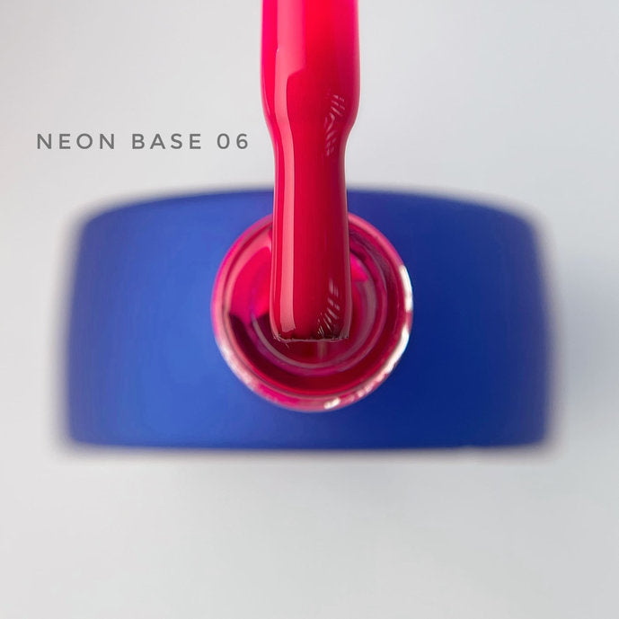 Neon pink gel nail polish brush above blue bottle, label reads Neon Base 06