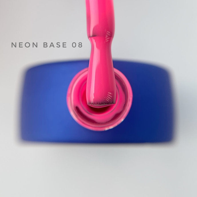 Bright pink neon gel nail polish brush above open blue bottle, labeled Neon Base 08