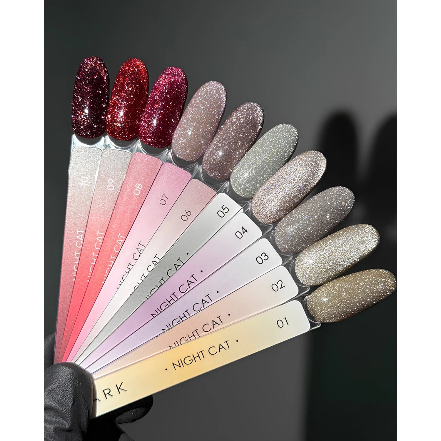 Assorted glitter gel nail polish color swatches for manicure, numbered 1 to 10 on display sticks