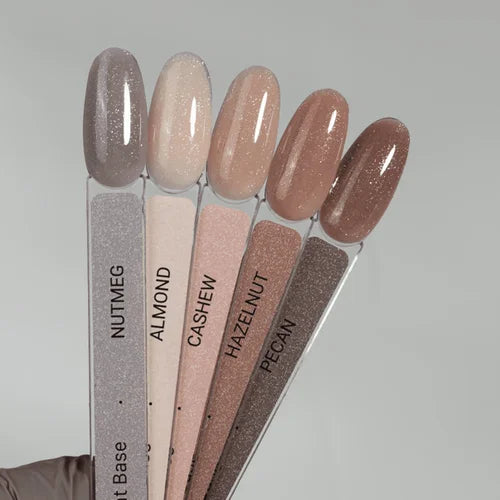 Neutral glitter gel nail polish swatches labeled nutmeg, almond, cashew, hazelnut, pecan