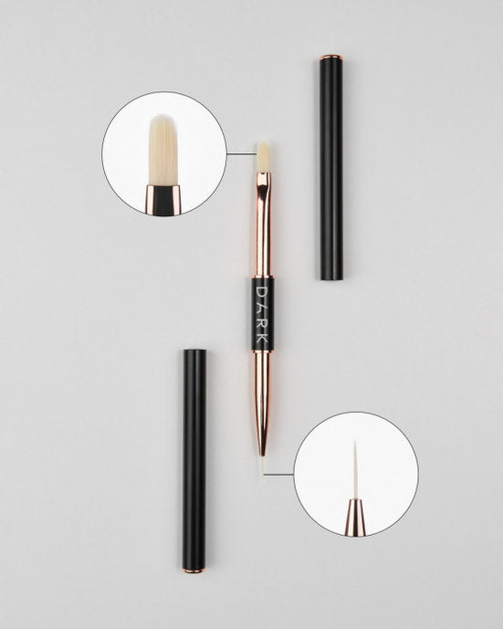 Dual-ended nail art brush with fine detail and flat gel tips, manicure tool on gray background