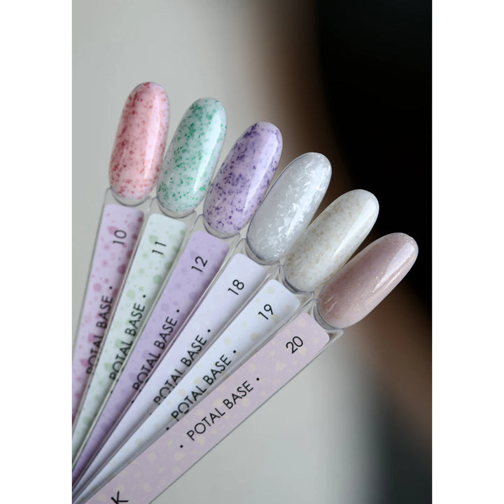 Set of nail polish bottles with pastel-colored nail samples on a white background
