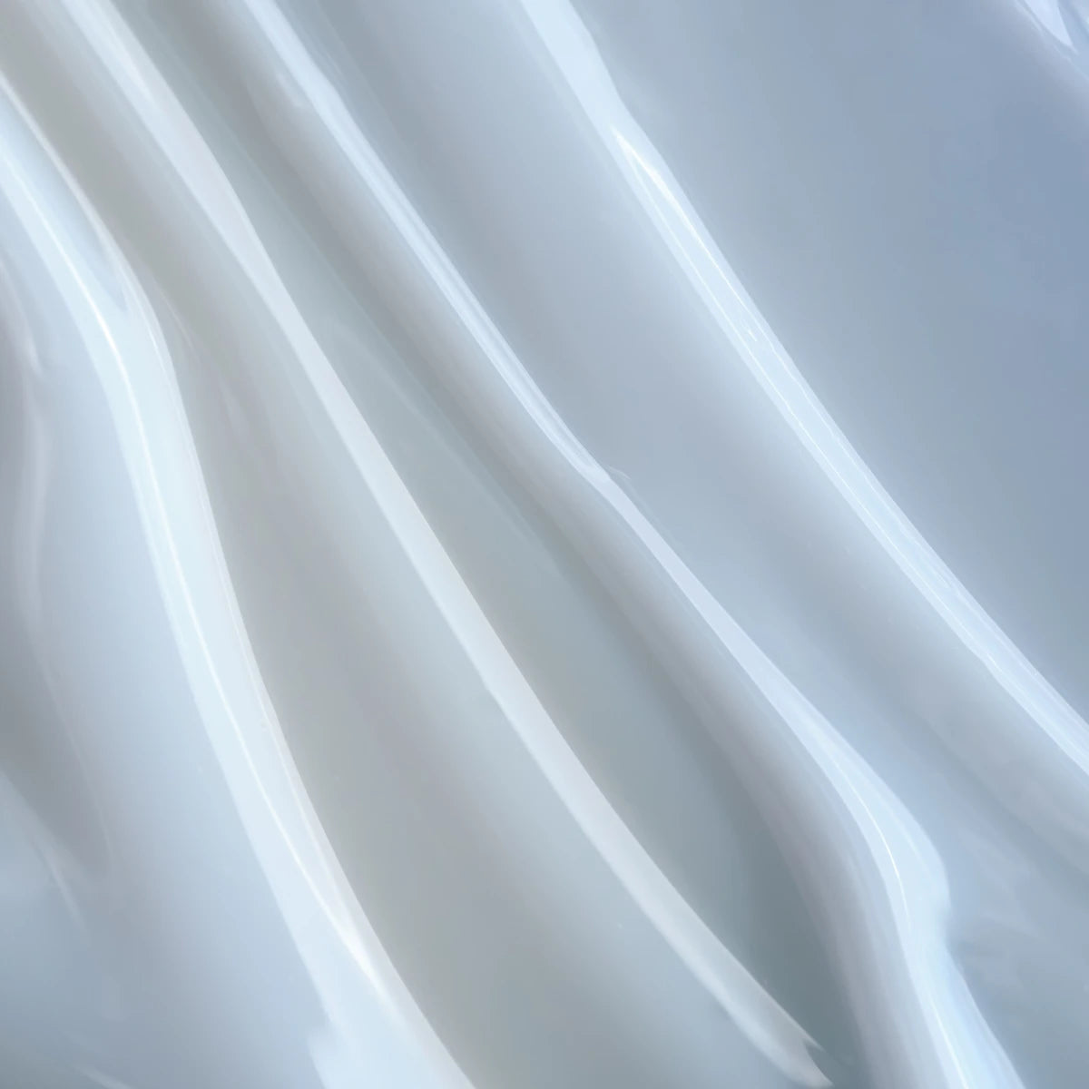 Close-up of milky white UV gel texture for professional manicure and nail art.