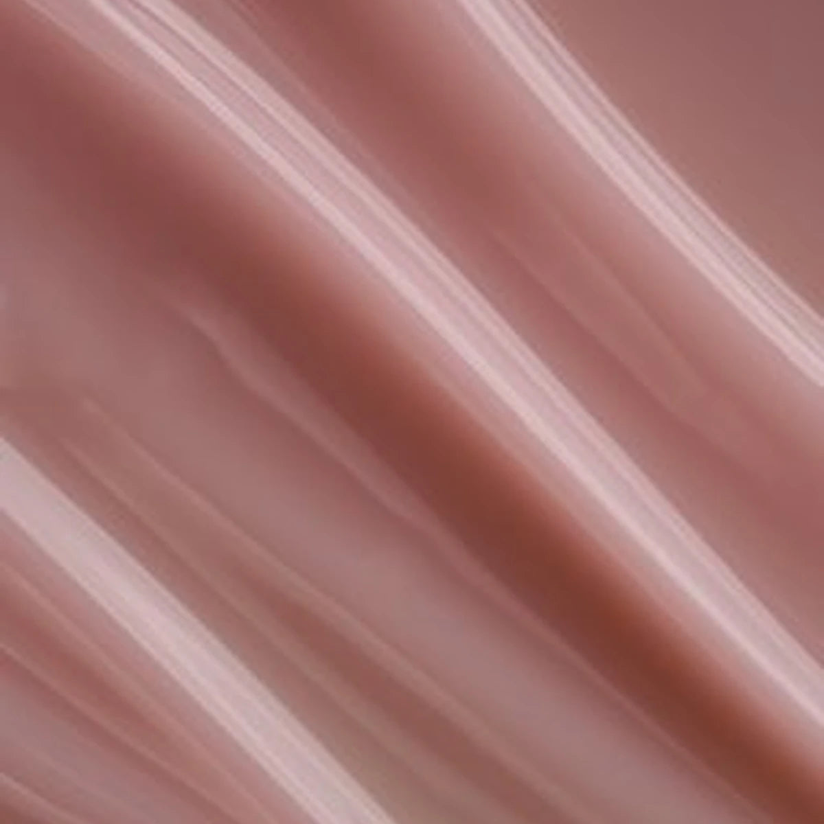 Close-up of glossy nude pink gel polish texture, ideal for manicures and nail art designs