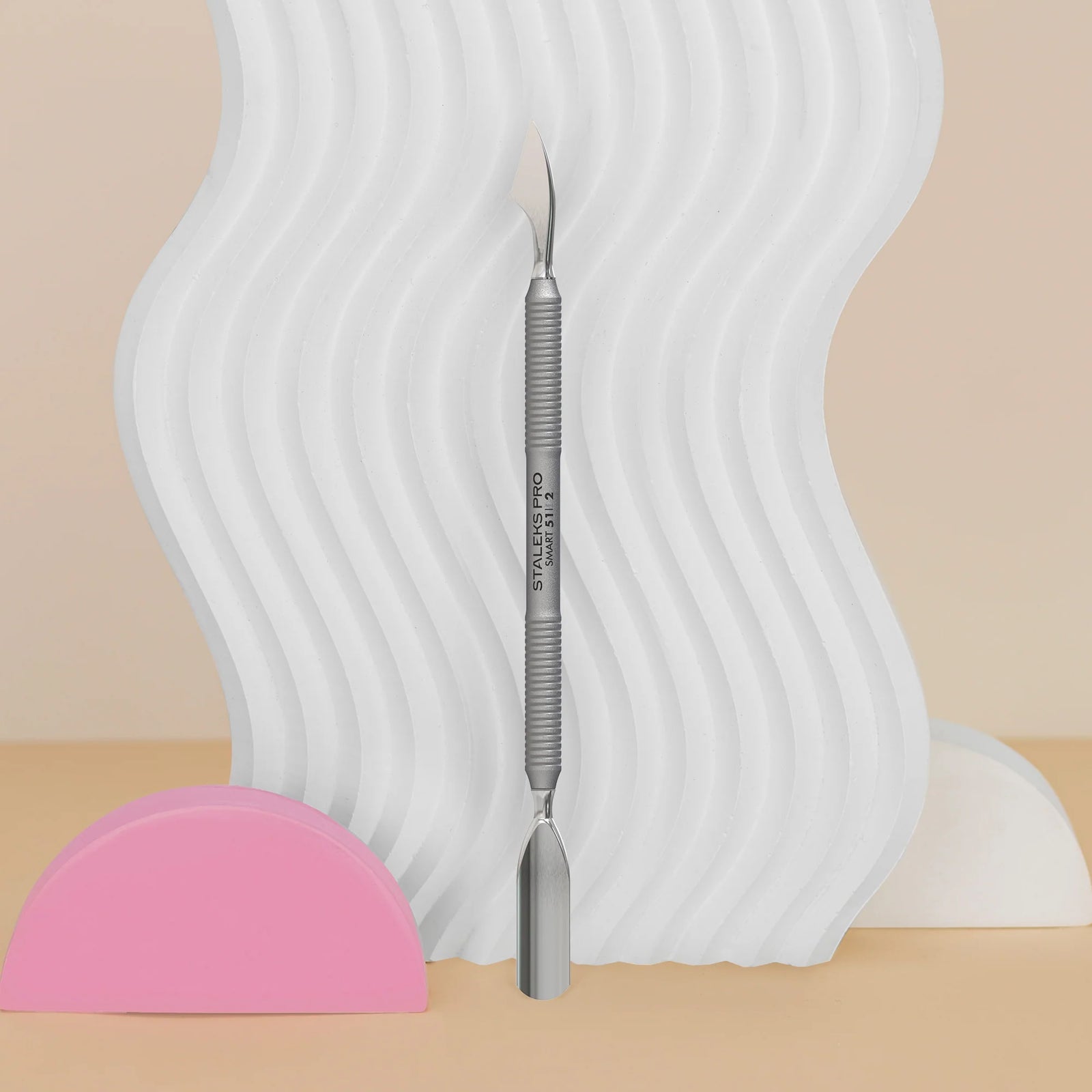 Double-ended stainless steel nail cuticle pusher tool with textured grip, manicure accessory